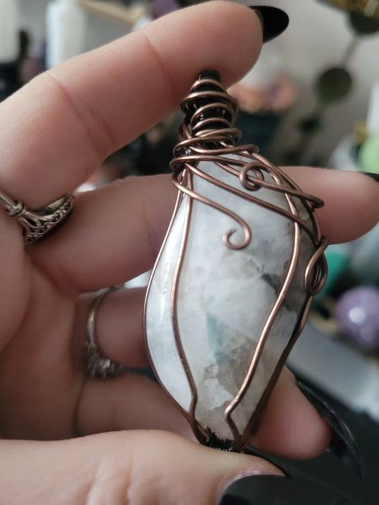 Moonstone w/ blue tourmaline inclusion